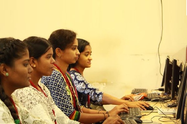 Rural women sitting in a circle during a self-help group meeting