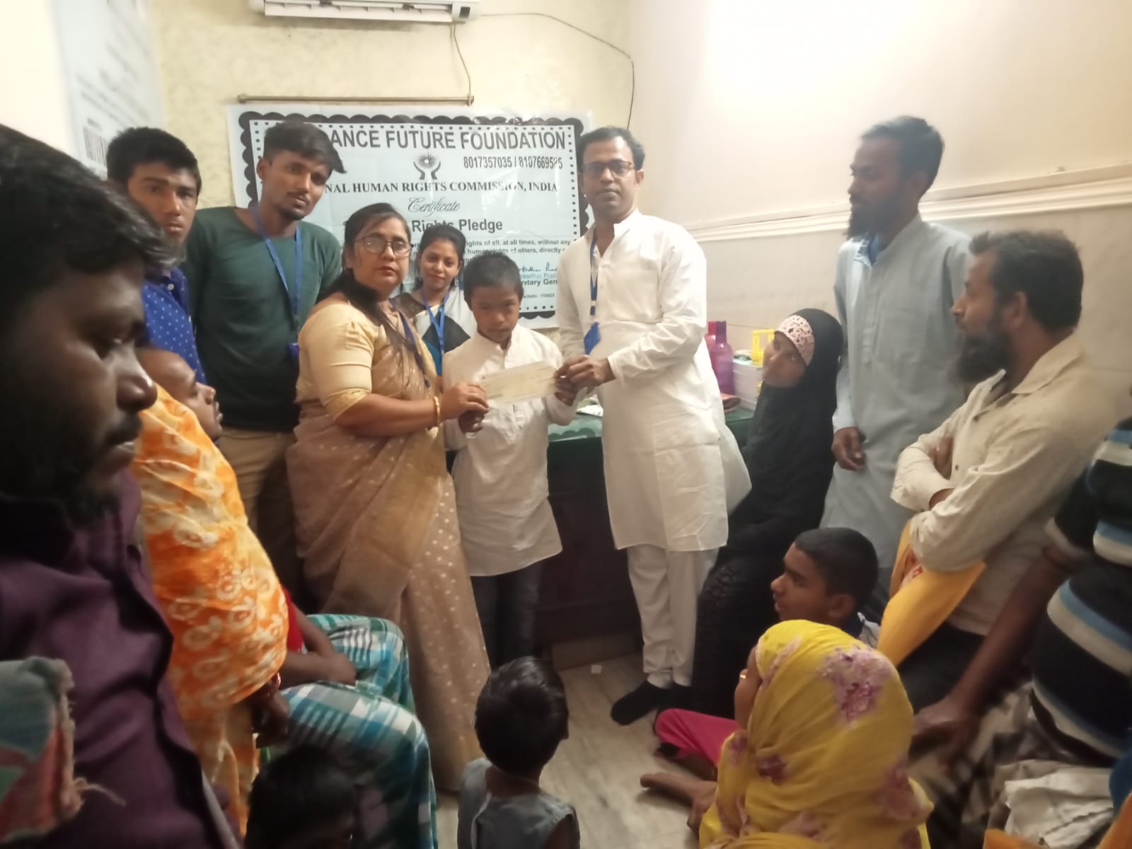 Volunteers and villagers gathered at a community programme